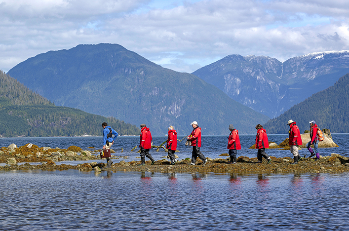 A group of guests walking across Knight Inlet, Canada
