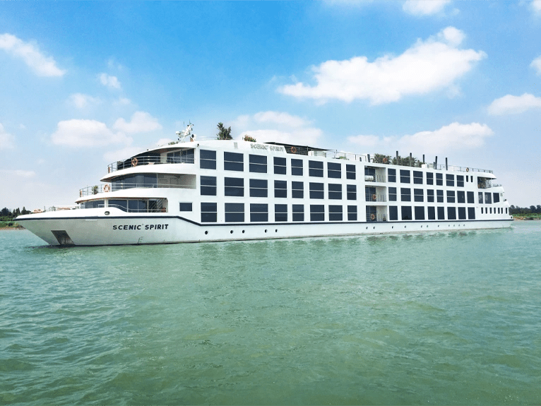 Scenic Spirit cruise ship on the Mekong River with a blue sky above