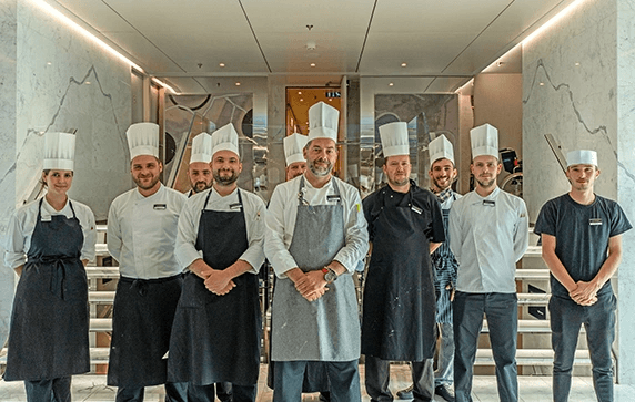 A group of Chefs wearing chef’s hats on the Scenic Sapphire cruise ship.