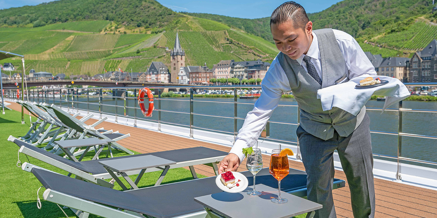 Customers with agent looking at travel brochure