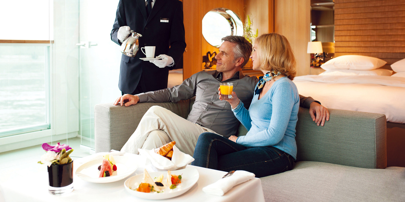 Couple having breakfast in their suite on board a river cruise