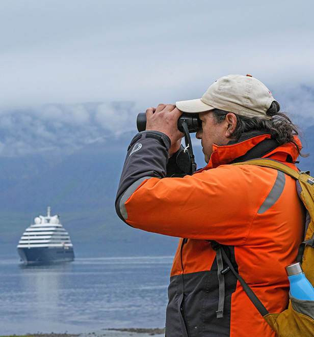 Man using binoculars in Iceland