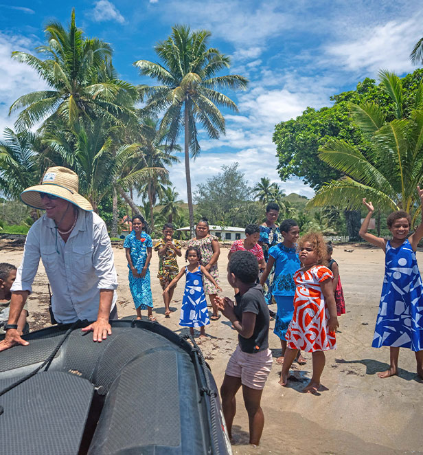 Locals in Loma Loma greeting people in a zodiac