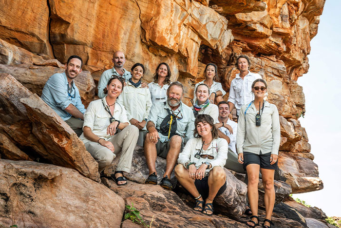 People standing under a rock in the Kimberley