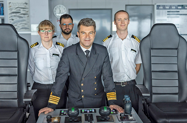 Scenic Eclipse crew members on the ship bridge