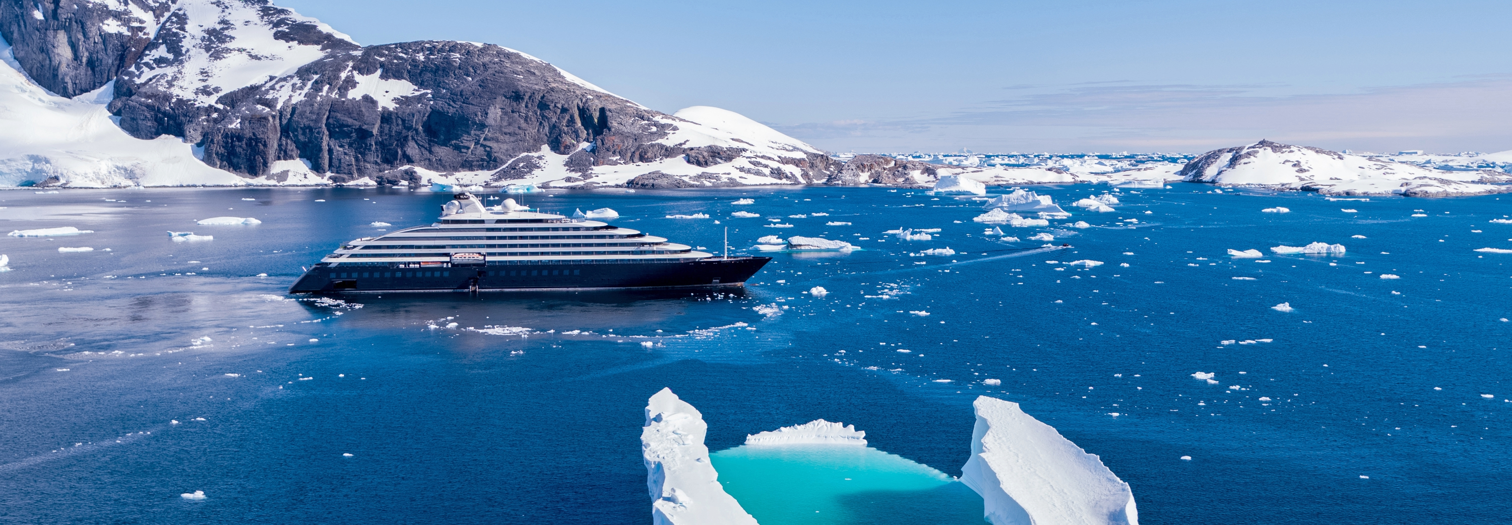 Scenic Eclipse cruise ship sailing through ice berg field off the coast of Antarctica
