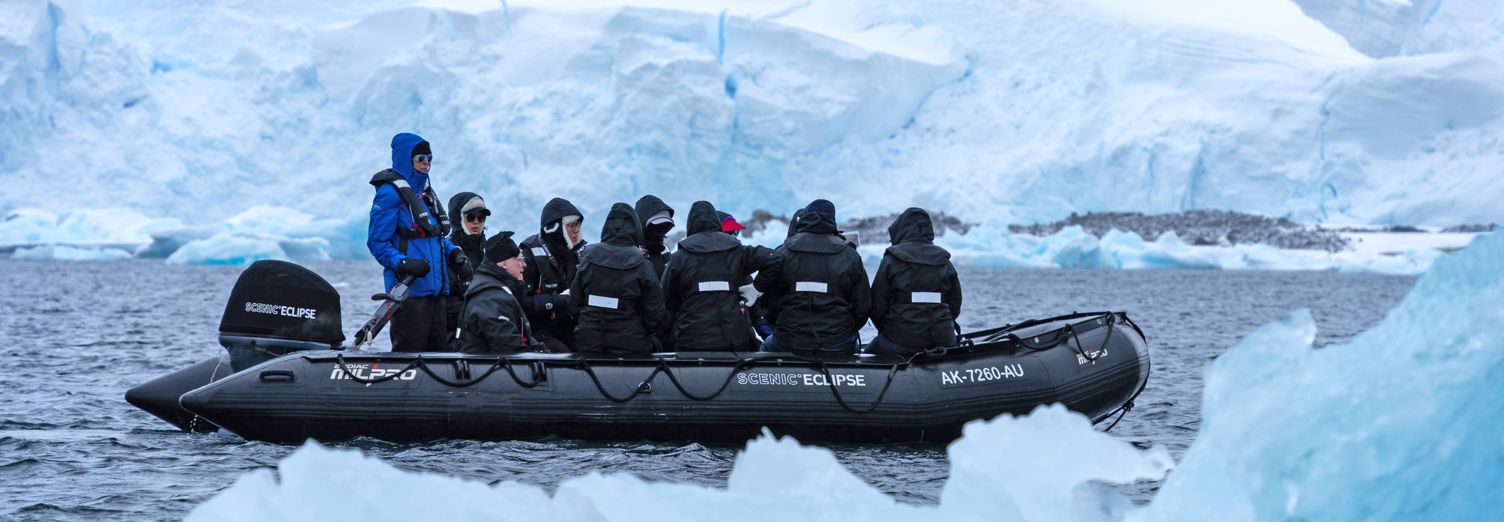 Tour group on small boat exploring ice bergs